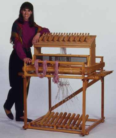 Photo of Tina with her favorite 16 harness loom.